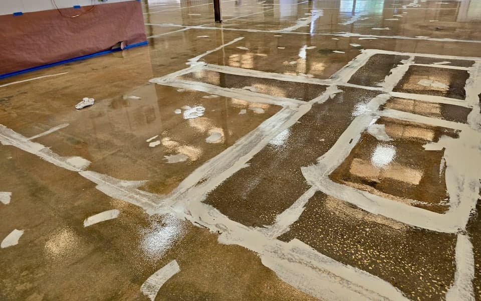 Concrete repair work across the prepared JAXPORT body shop slab