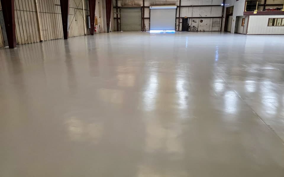 Finished epoxy flooring extending across the JAXPORT automotive service facility